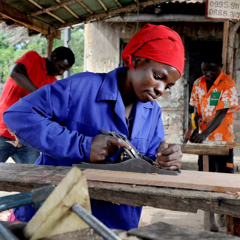 A woman using carpentry tools